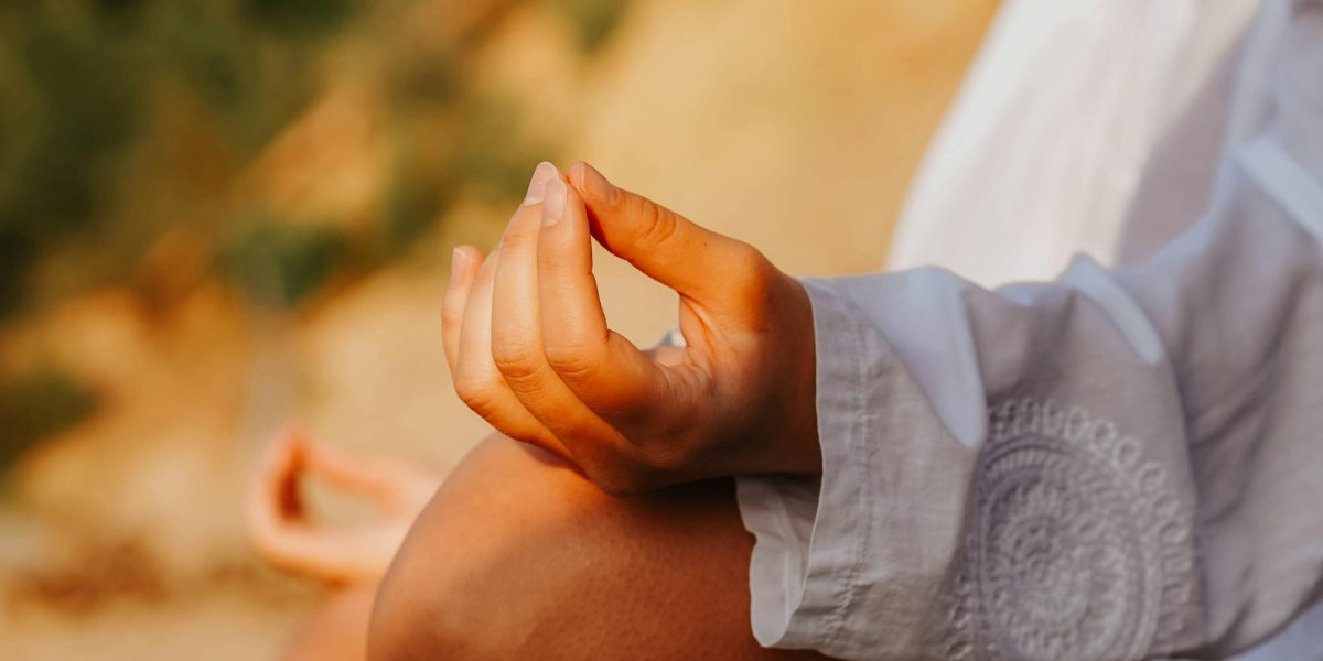 A person calmly practicing deep breathing in a peaceful outdoor setting, demonstrating an immediate stress-reduction technique.