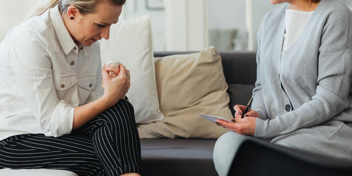 A therapist and client engaged in a supportive conversation, highlighting the importance of trust in the therapeutic process.