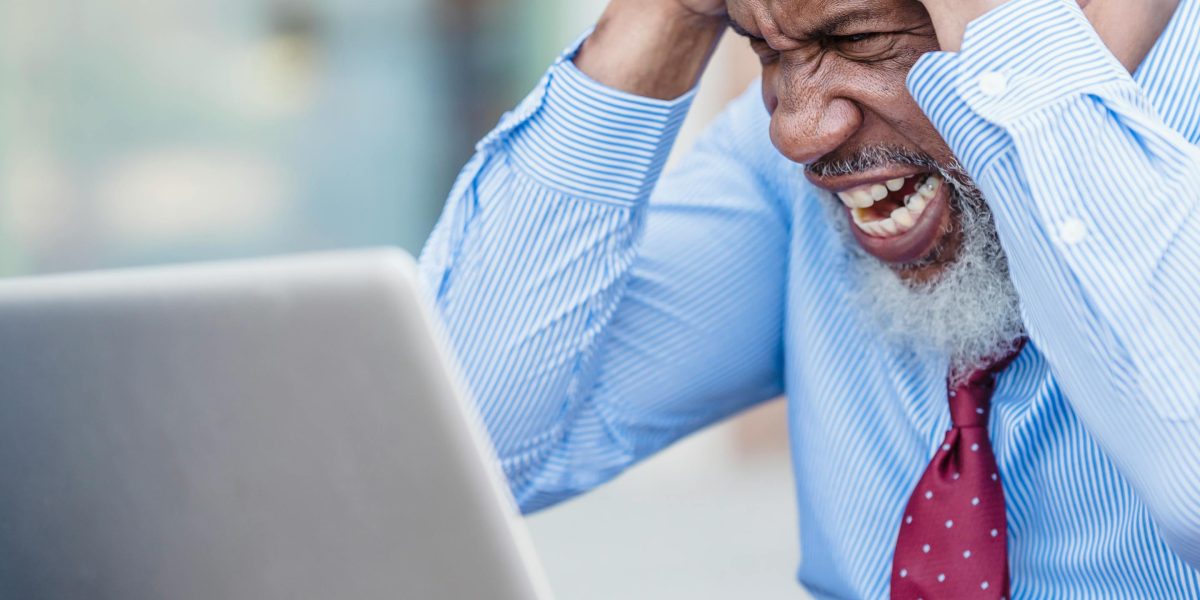 A person struggling to navigate complex healthcare systems or feeling blocked by financial and bureaucratic hurdles to access mental health support.