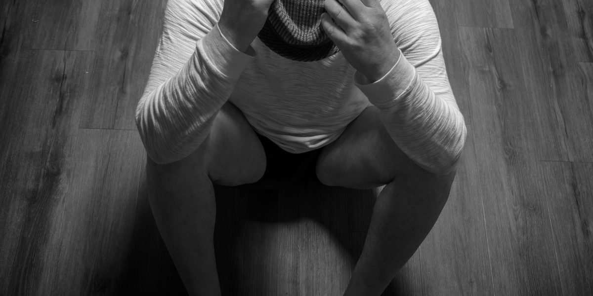 A person with a serious, somewhat detached expression, symbolizing the emotional wall and lack of empathy associated with ASPD.