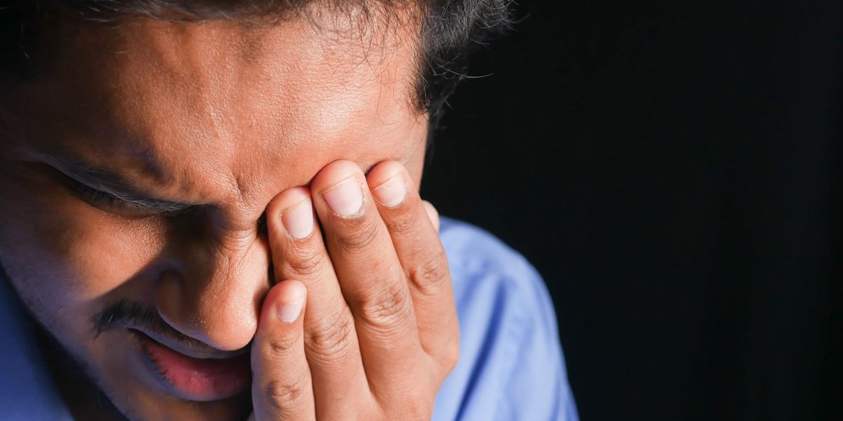 An adult grappling with internal frustration, reflecting the quiet, damaging patterns of undiagnosed ODD.