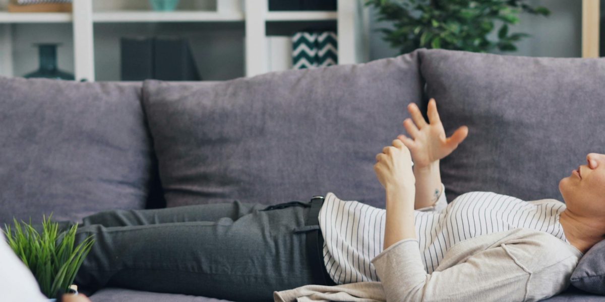 A person engaged in a therapy session, discussing complex emotional overlaps like ODD and depression with a professional.