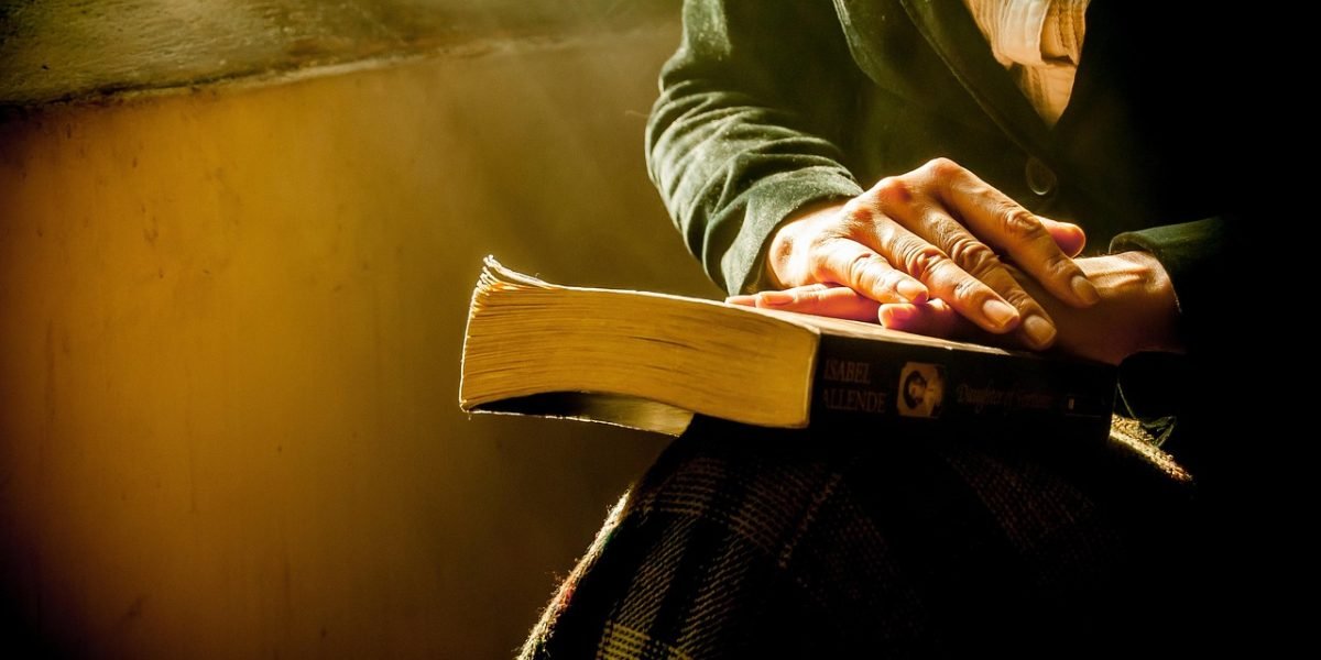 A person looking thoughtful and slightly overwhelmed while reading, reflecting the challenge of encountering difficult text.