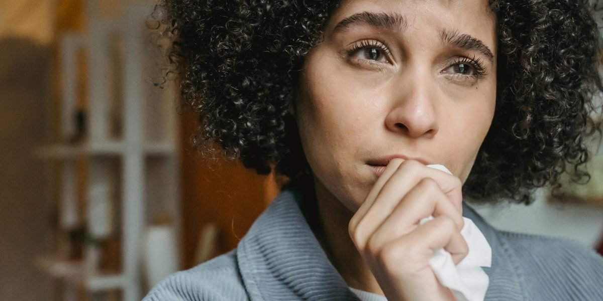 A person deep in thought, perhaps feeling the weight of serious mental health concerns and uncertainty.