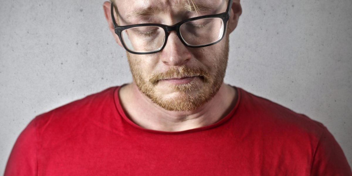 An adult facing internal struggles, reflecting the frustration and isolation often experienced by individuals with ODD.