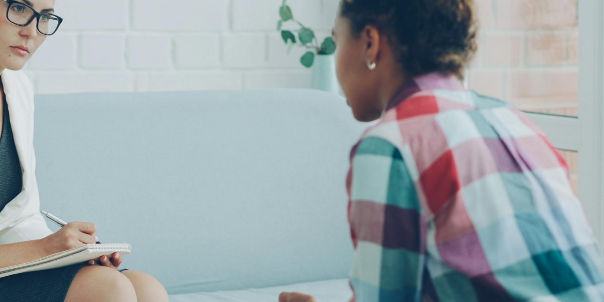 An individual engaging in a supportive conversation with a professional, symbolizing the act of reaching out for mental health resources.