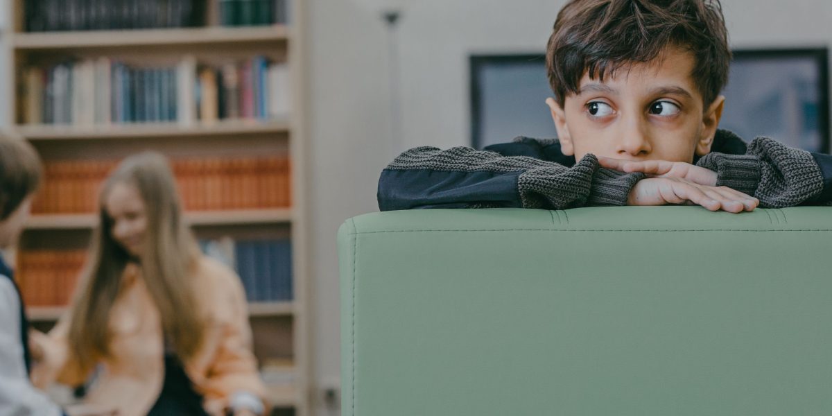 A child looking contemplative or a little withdrawn, representing the impact of early environmental factors.