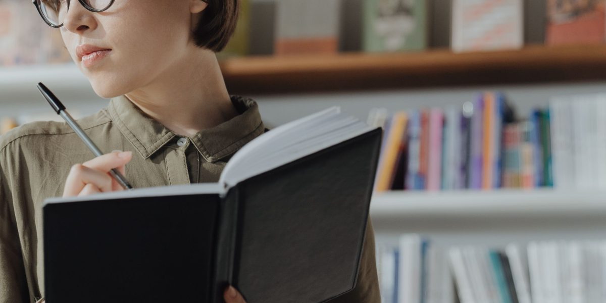 A person engaging in reflective writing in a journal, processing thoughts and emotions.