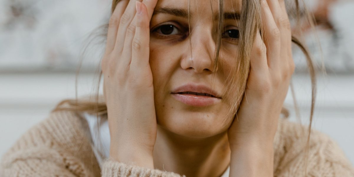 A person experiencing feelings of overwhelm or stress, reflecting the onset of panic.