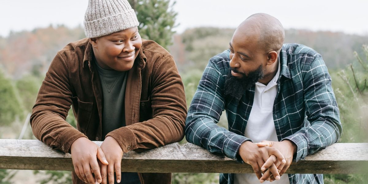 Two people engaged in a supportive conversation, emphasizing the importance of human connection and reaching out.