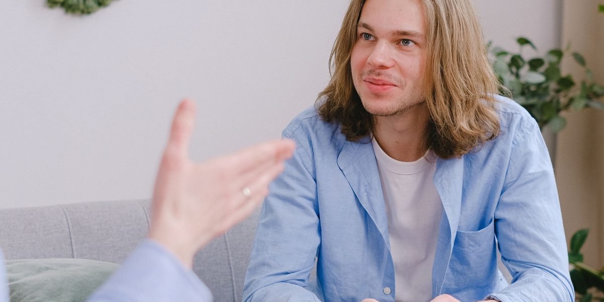 A therapist actively listening to a patient during a calm and supportive session.