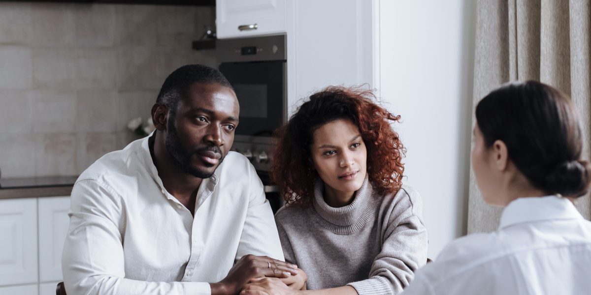 A family engaging in open and supportive communication around a kitchen table, fostering understanding.
