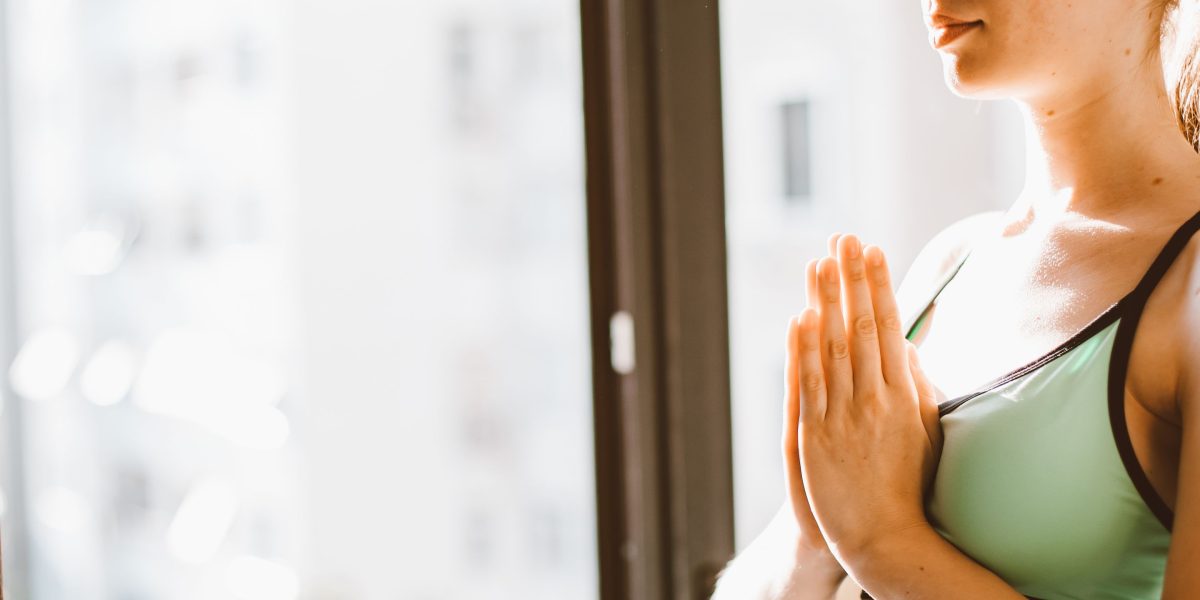 An individual practices a calming activity, highlighting the importance of self-management strategies for mental well-being.