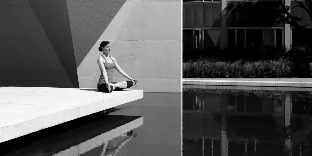 A person engaging in deep breathing outdoors to calm their nervous system and break an anxiety cycle.