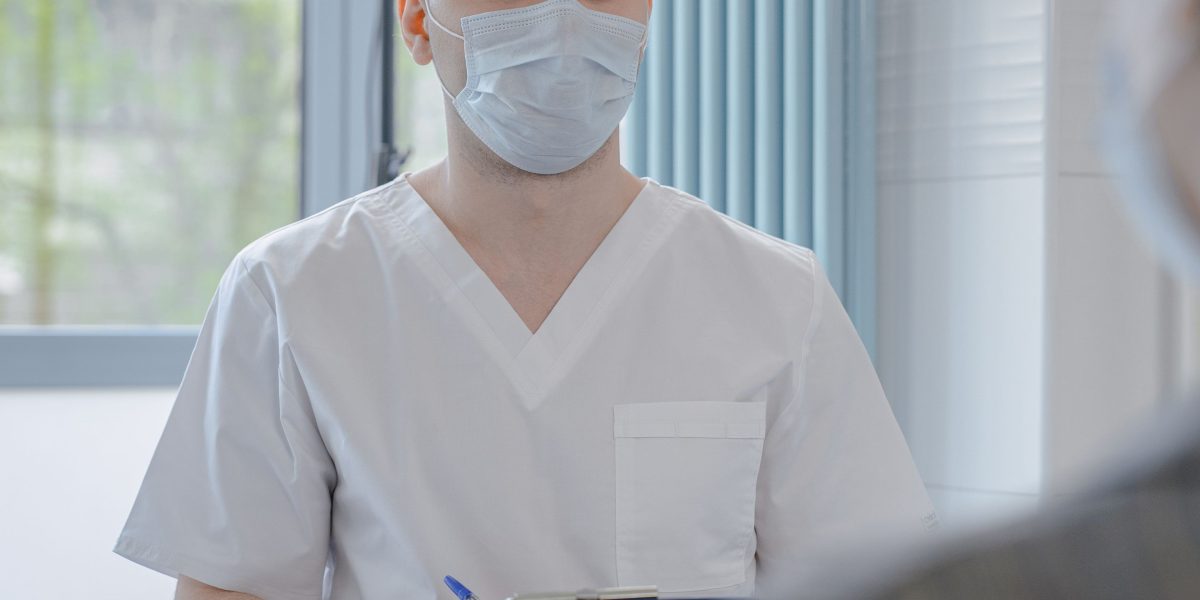 A patient engaged in a serious conversation with a doctor, symbolizing the importance of medical consultation to rule out other health conditions.