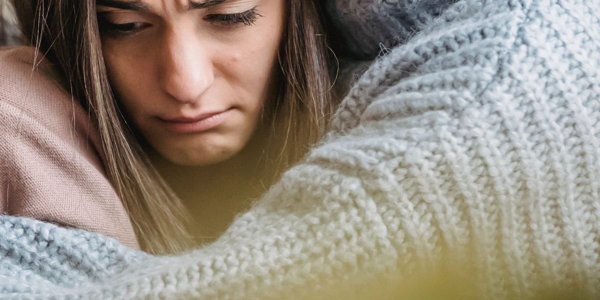 One person comforting another, demonstrating the vital role of empathetic support from friends and family during difficult times.